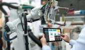 Engineer hand using tablet, heavy automation robot arm machine in smart factory industrial with tablet real time monitoring system application. Industry 4th iot concept.